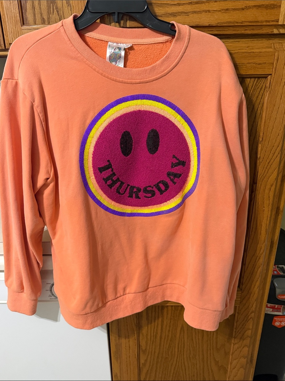 QUEEN OF SPARKLES Peach Crewneck Sweatshirt with Smiley Patch